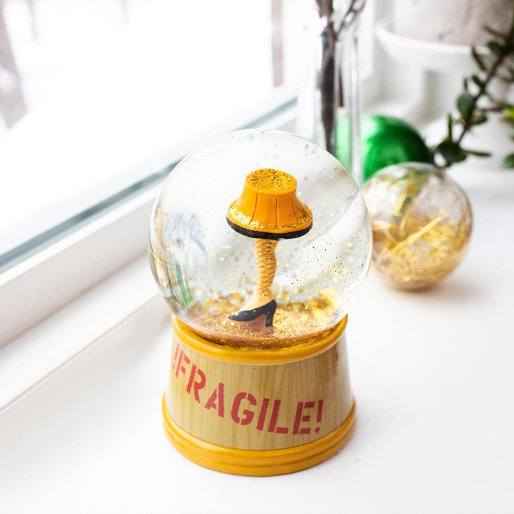 A Christmas Story Leg Lamp 3-Inch Mini and 6-Inch Large Light-Up Snow Globe Set